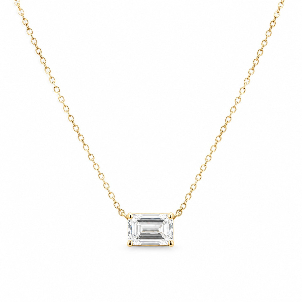 Gold necklace with a rectangular diamond pendant on a white background