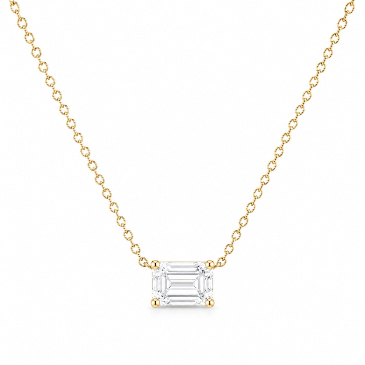 Gold necklace with an emerald-cut diamond pendant on a white background