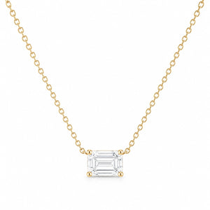 Gold necklace with an emerald-cut diamond pendant on a white background