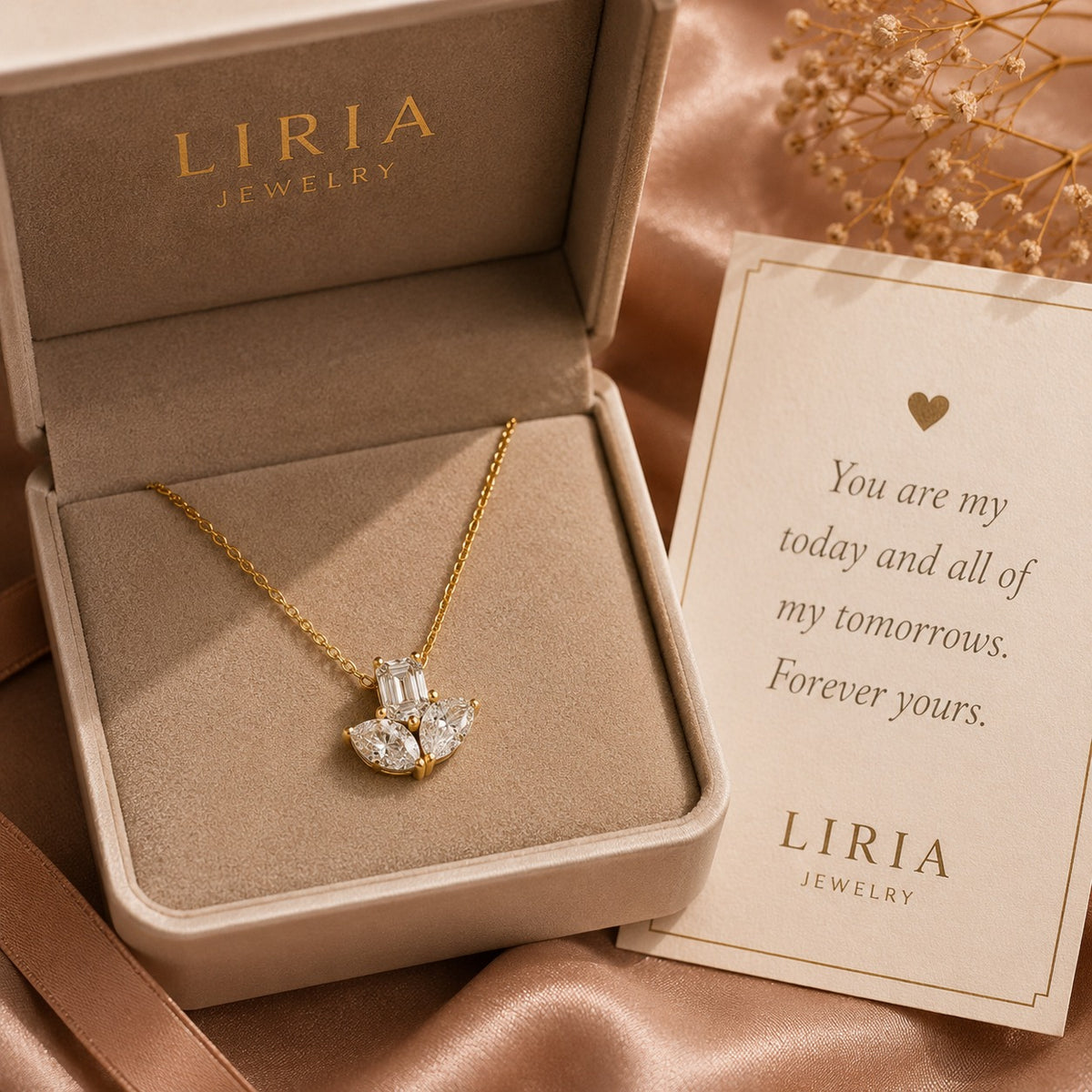 Gold necklace with a heart-shaped pendant in an open LIRIA Jewelry box on a satin surface.