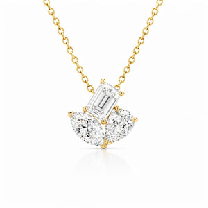 Yellow gold diamond pendant necklace featuring an emerald-cut center diamond accented by two pear-shaped diamonds on a delicate chain, displayed on a light gray background.