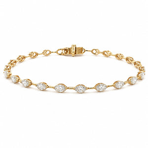 A yellow gold tennis bracelet featuring a series of marquise-cut and round diamonds set along the chain, displayed on a clean white background.