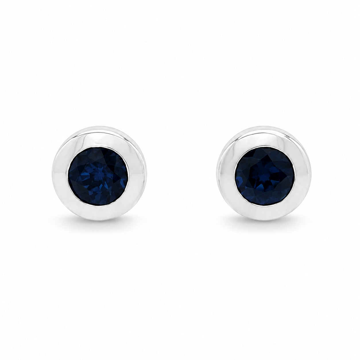 Pair of silver earrings with clear gemstones on a white background