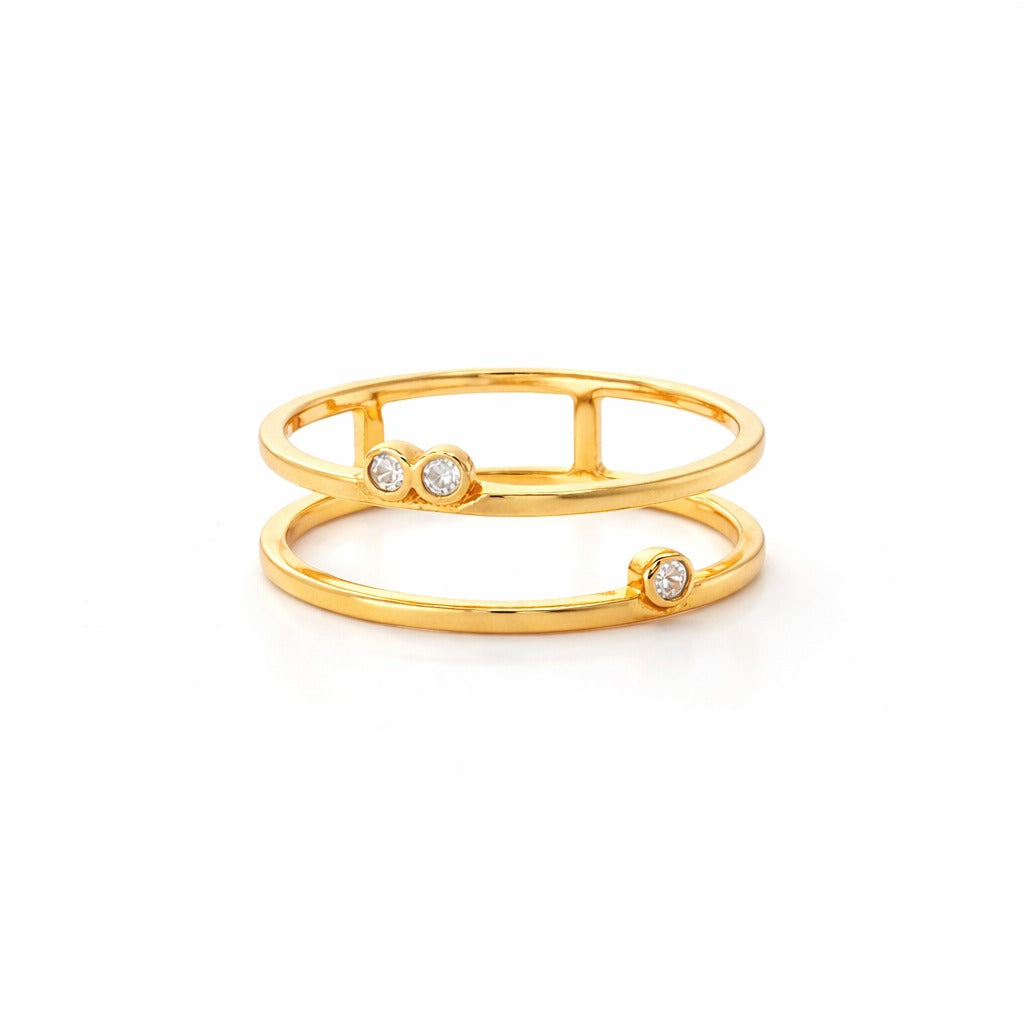 Gold ring with embedded stones on a white background