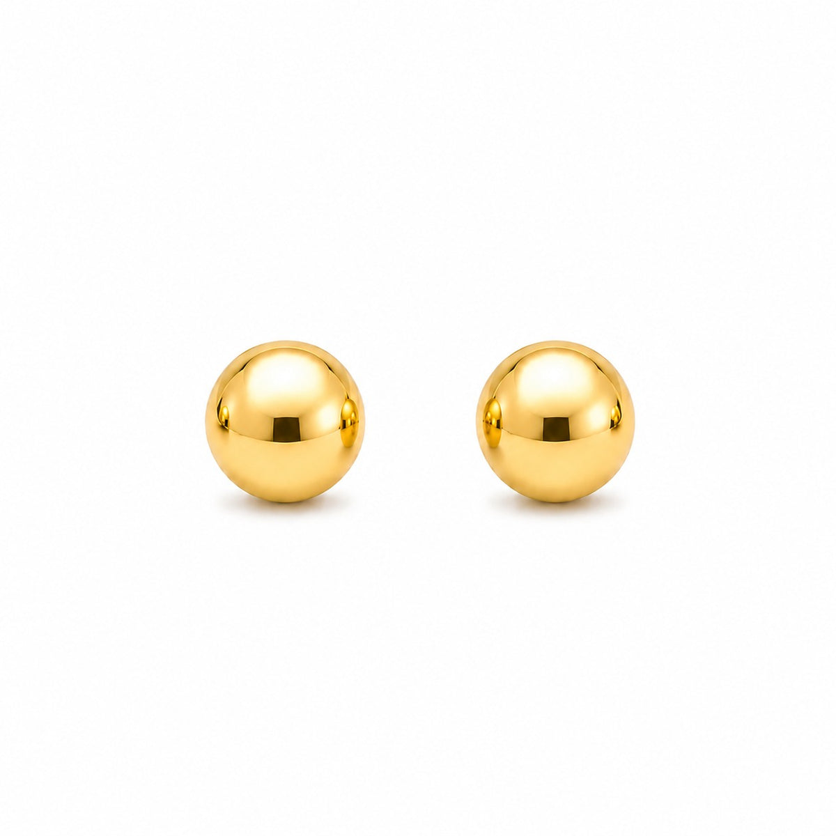 Pair of gold spherical earrings on a white background