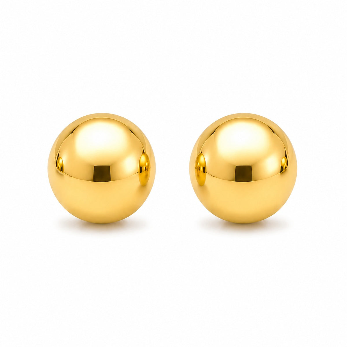 Pair of gold spherical earrings on a white background