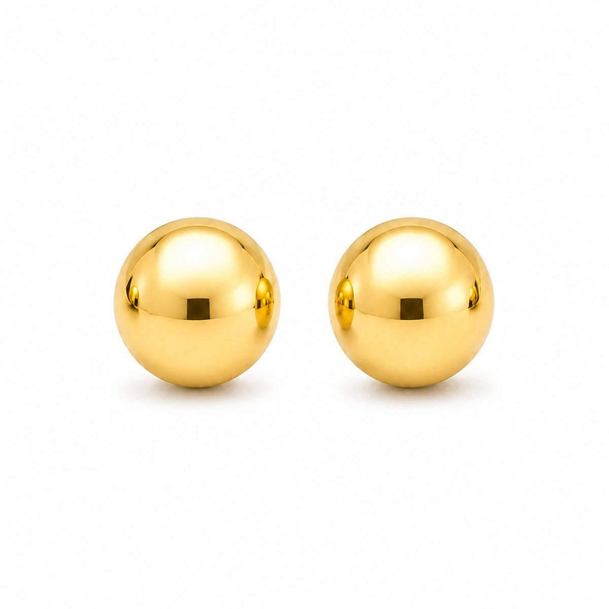 Pair of gold spherical earrings on a white background