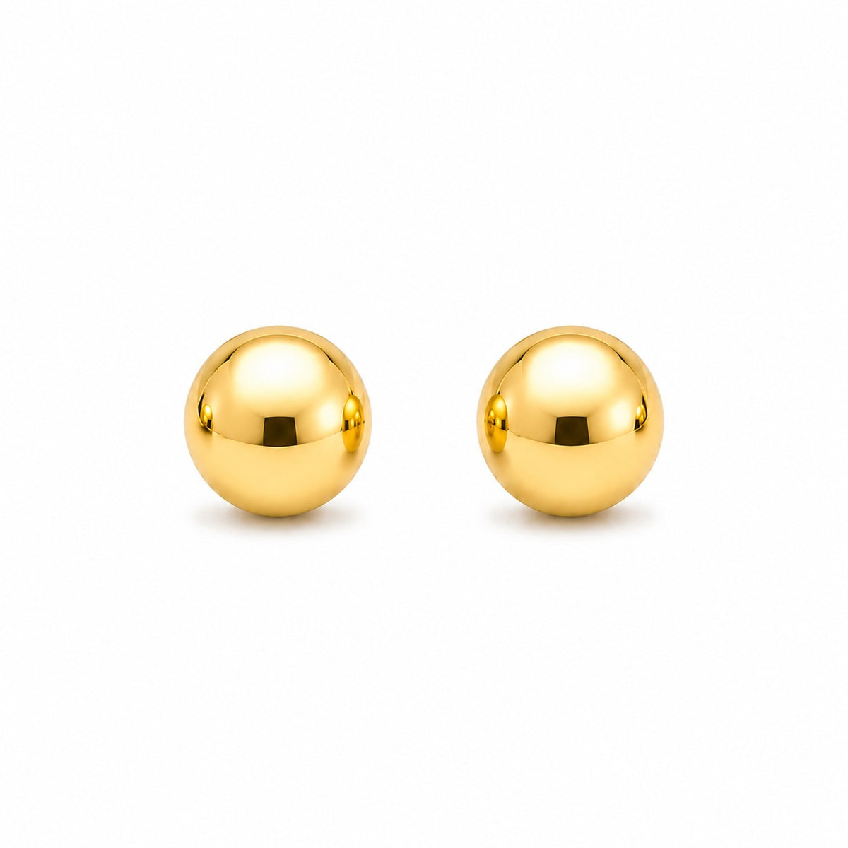Pair of gold spherical stud earrings on a white background