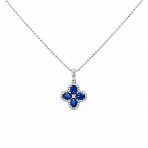 A 14K white gold bead chain necklace featuring a four-leaf clover pendant set with four vivid blue diamonds, accented by a sparkling halo of round white diamonds and a cluster at the centerdiamond , displayed on a clean white studio background.