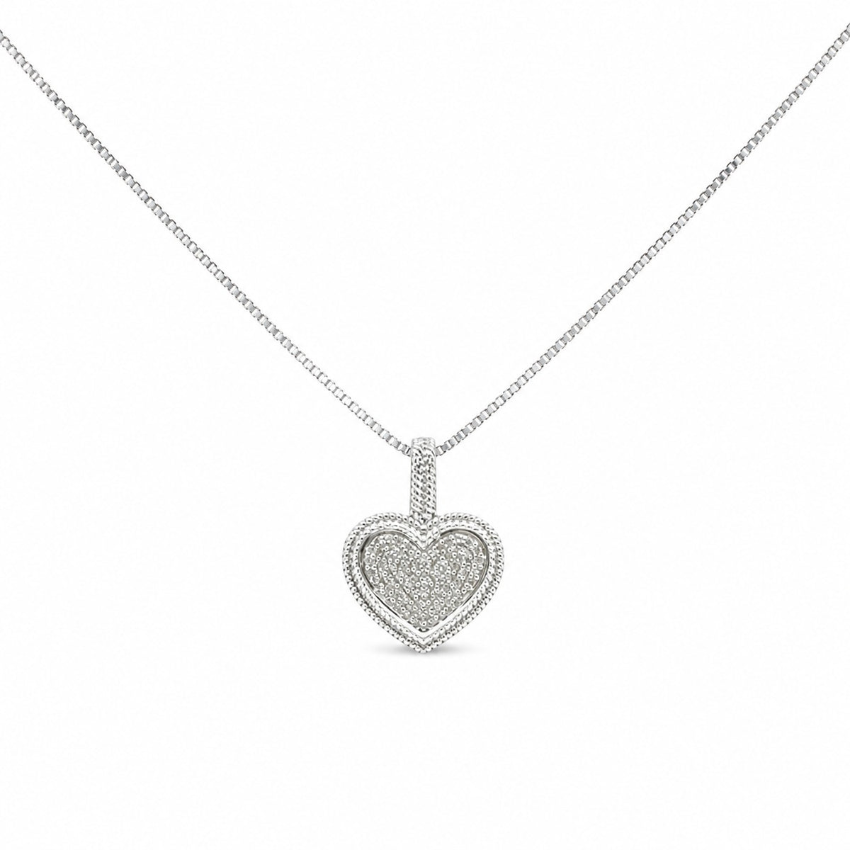 Heart-shaped diamond pendant on a chain against a white background