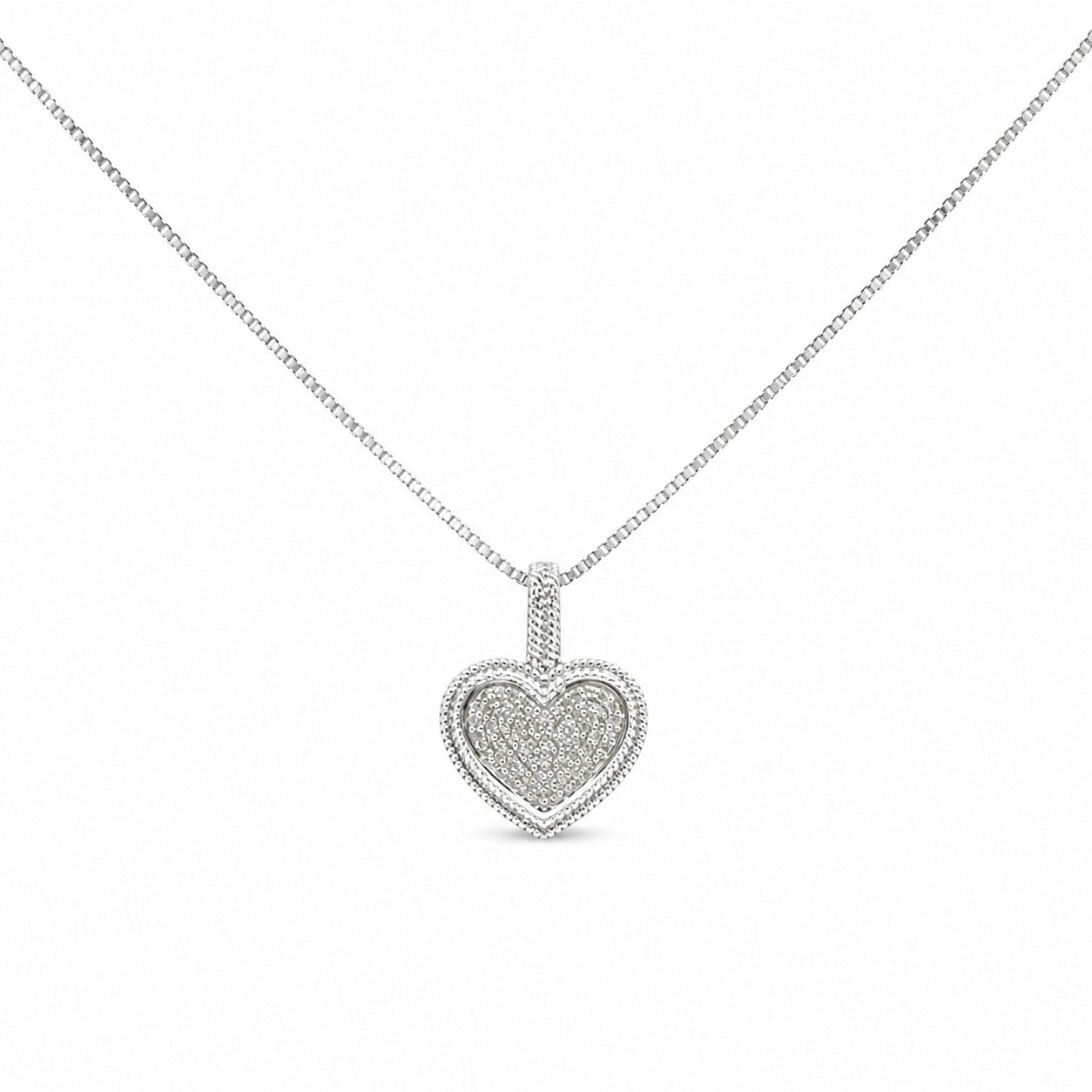 Heart-shaped diamond pendant on a chain against a white background