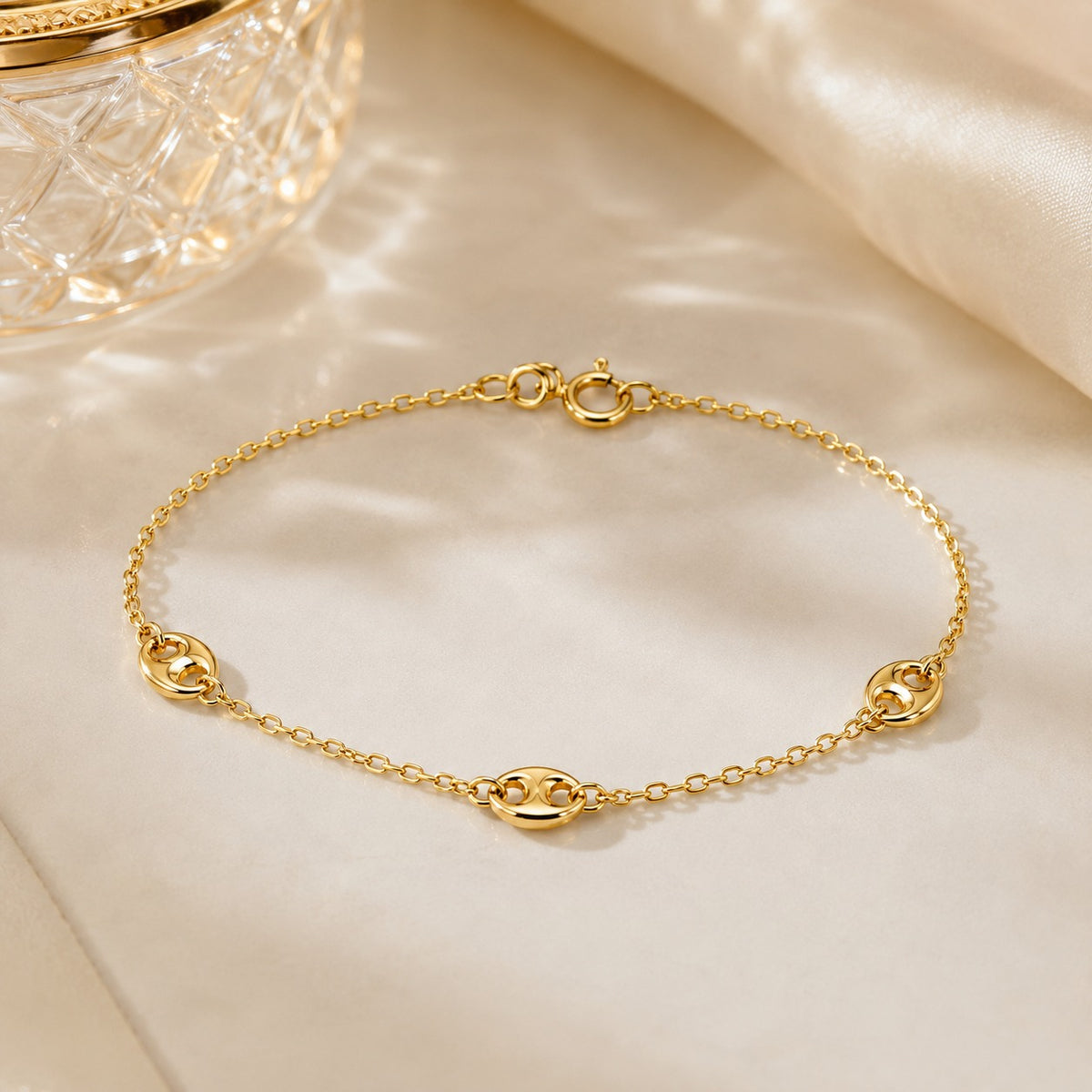 Gold bracelet on a beige fabric background