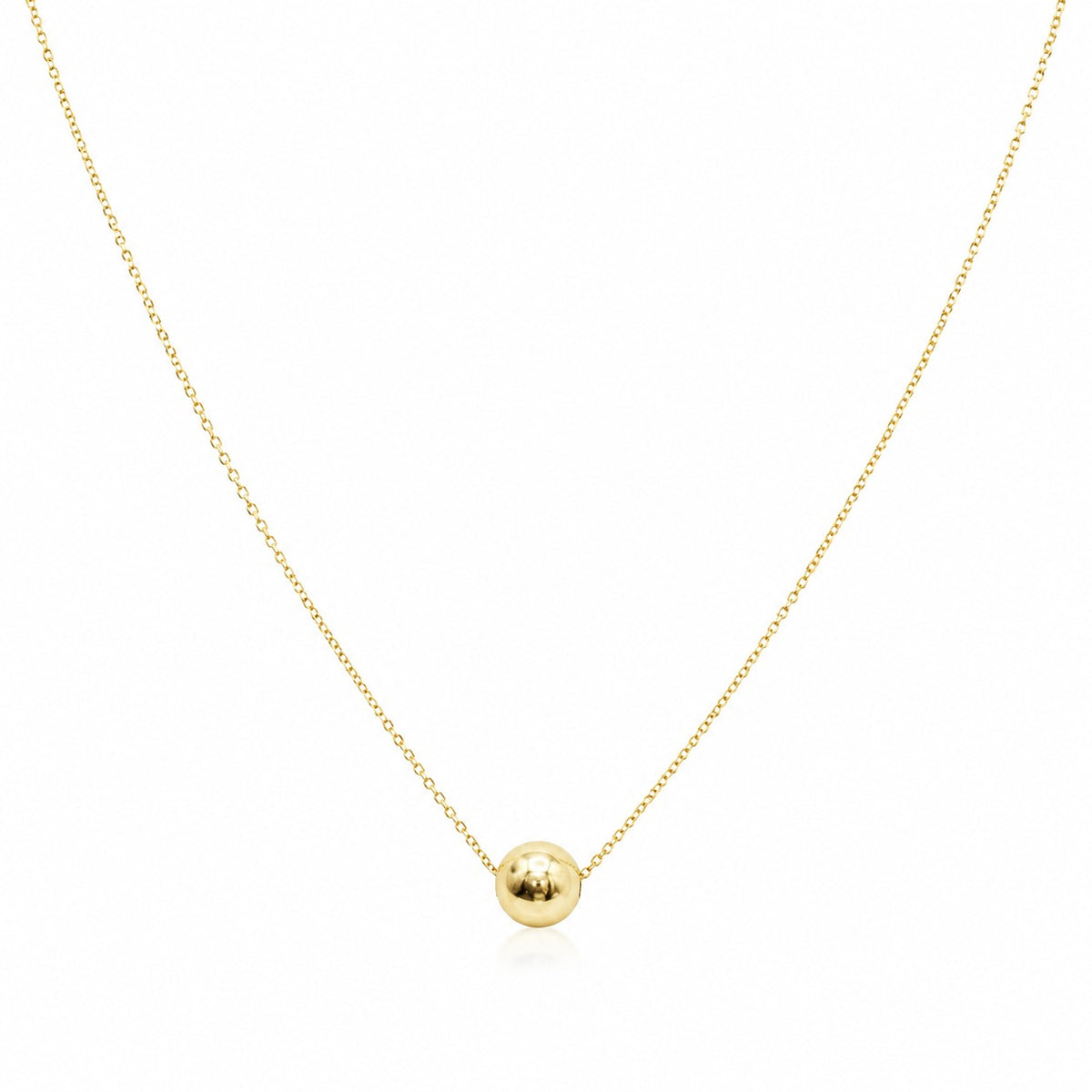 Gold necklace with a small round pendant on a white background