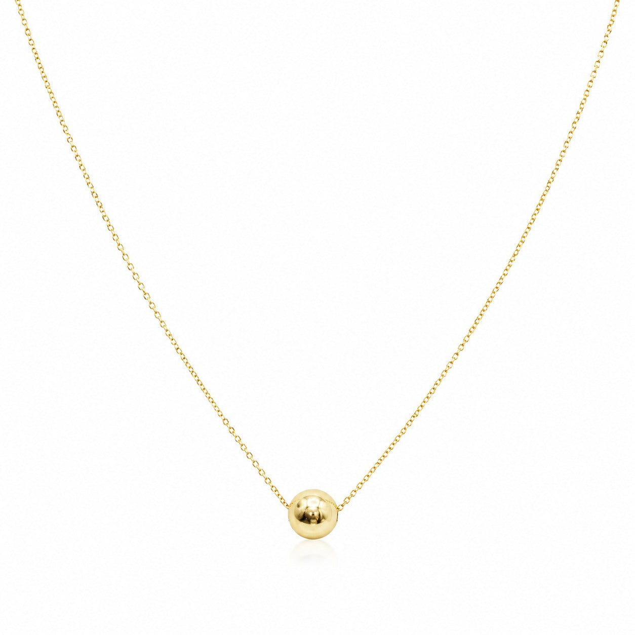 Gold necklace with a small round pendant on a white background