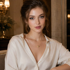 Woman wearing a white blouse with a chandelier in the background