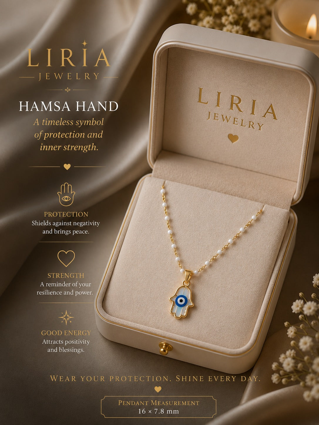 A Liria Jewelry Hamsa hand pendant necklace displayed in an open beige jewelry box, with decorative draped fabric, dried flowers, and a lit candle in the background. Text on the left describes the protection and symbolism of the Hamsa hand pendant.