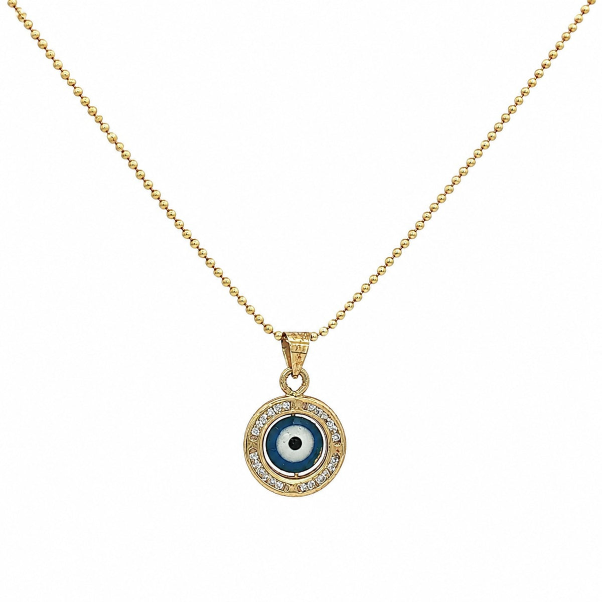 A gold chain necklace with a circular evil eye pendant. The pendant features a blue and white eye design surrounded by a halo of small clear crystals, set against a plain white background.