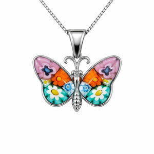 Butterfly-shaped pendant with colorful wings on a white background