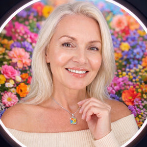 Woman wearing a colorful necklace with a floral background