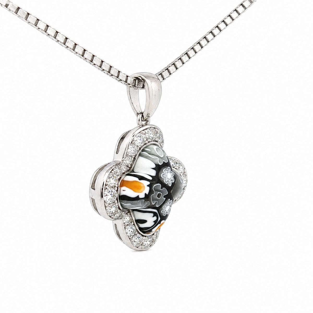 Silver pendant with a heart design on a white background