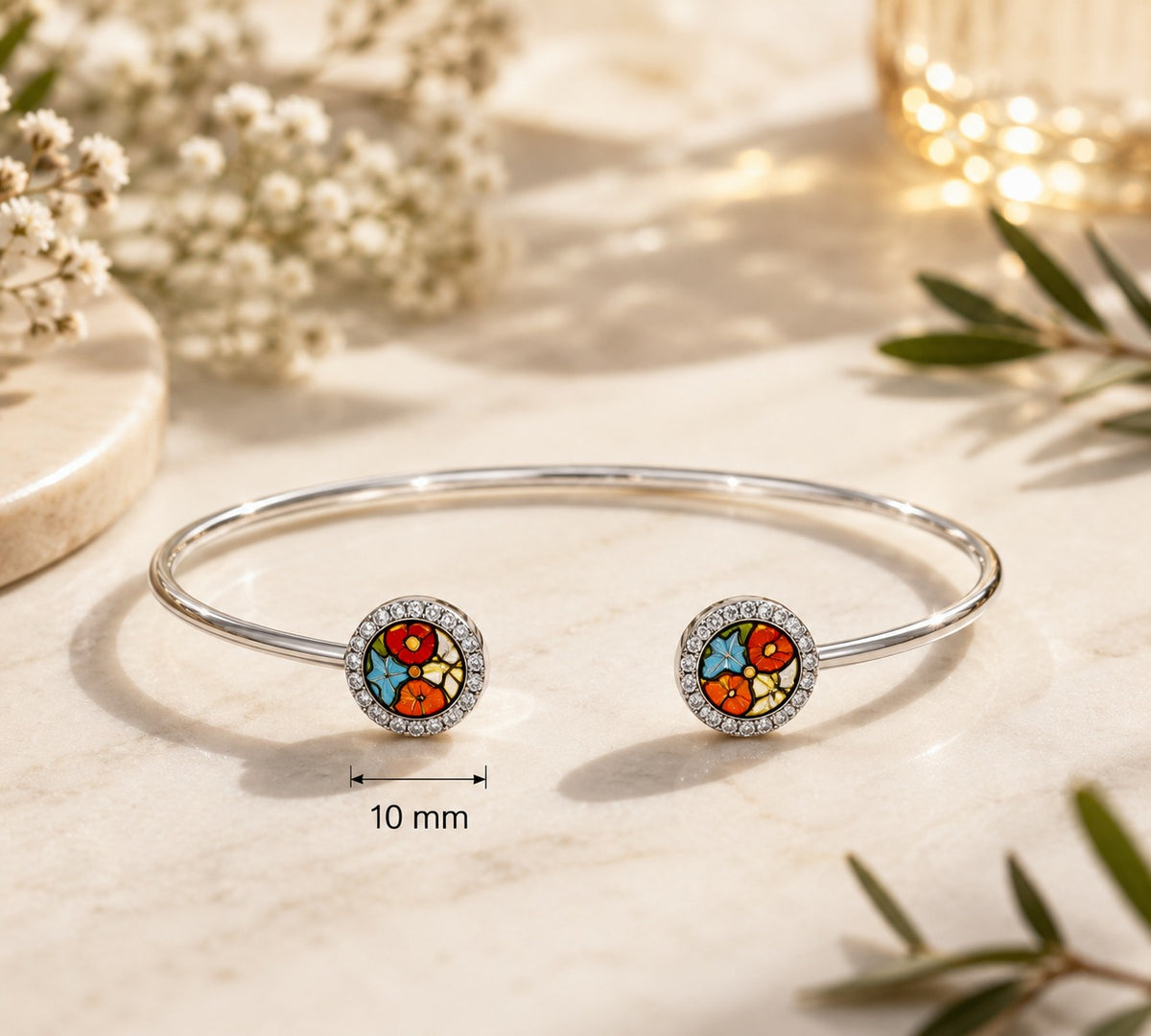 Open silver bangle bracelet with two round multicolor ends and crystal halo detail