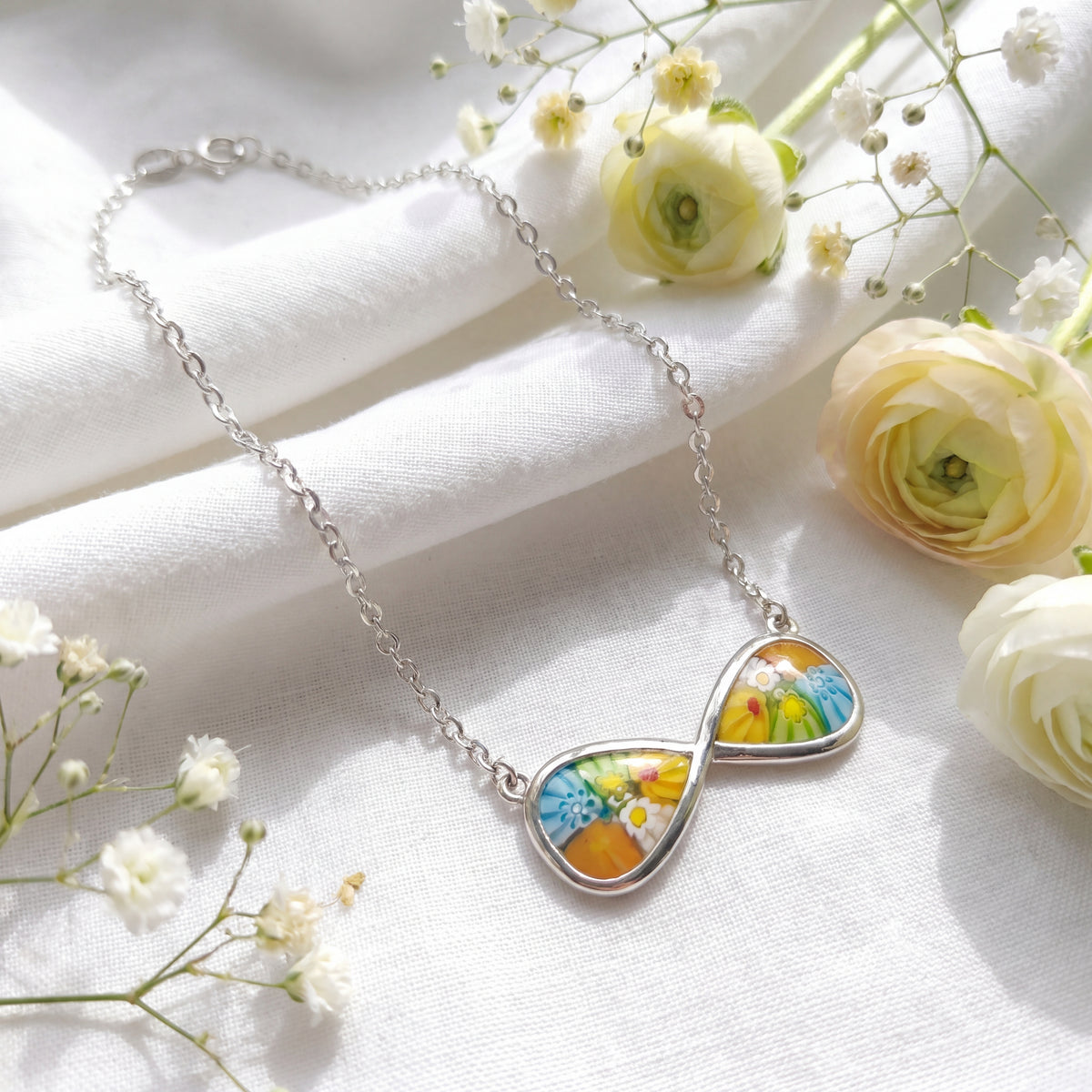 Necklace with floral pendant on a white fabric background