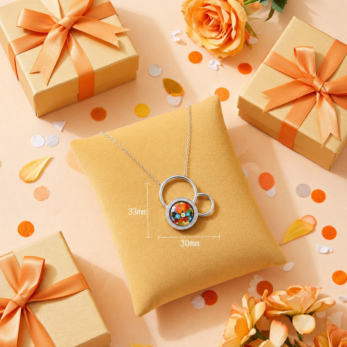Necklace with a colorful pendant on a yellow pillow surrounded by gift boxes and flowers on a peach background