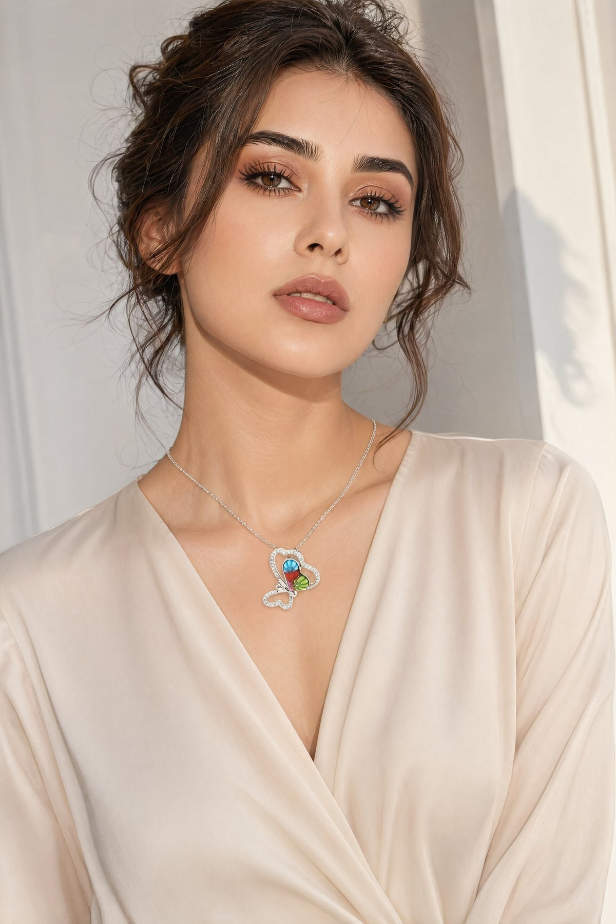 Woman wearing a necklace with a colorful pendant against a neutral background