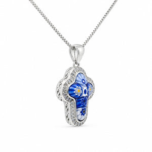 Silver pendant with blue and white floral design on a white background