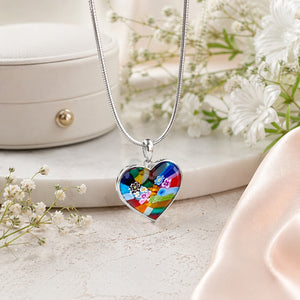 Colorful heart-shaped pendant on a silver chain with a white floral background