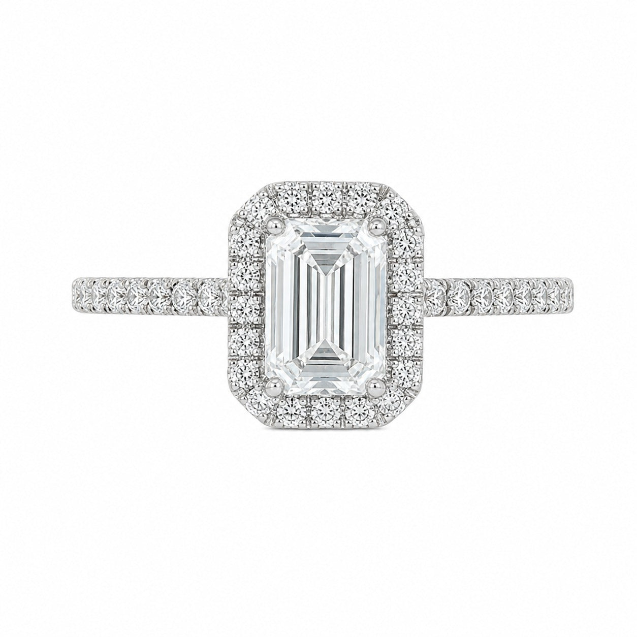 An emerald-cut halo ring featuring a central baguette diamond surrounded by a double halo of smaller round diamonds, with a pavé-set band in a silver-colored metal, shown on a plain white background.