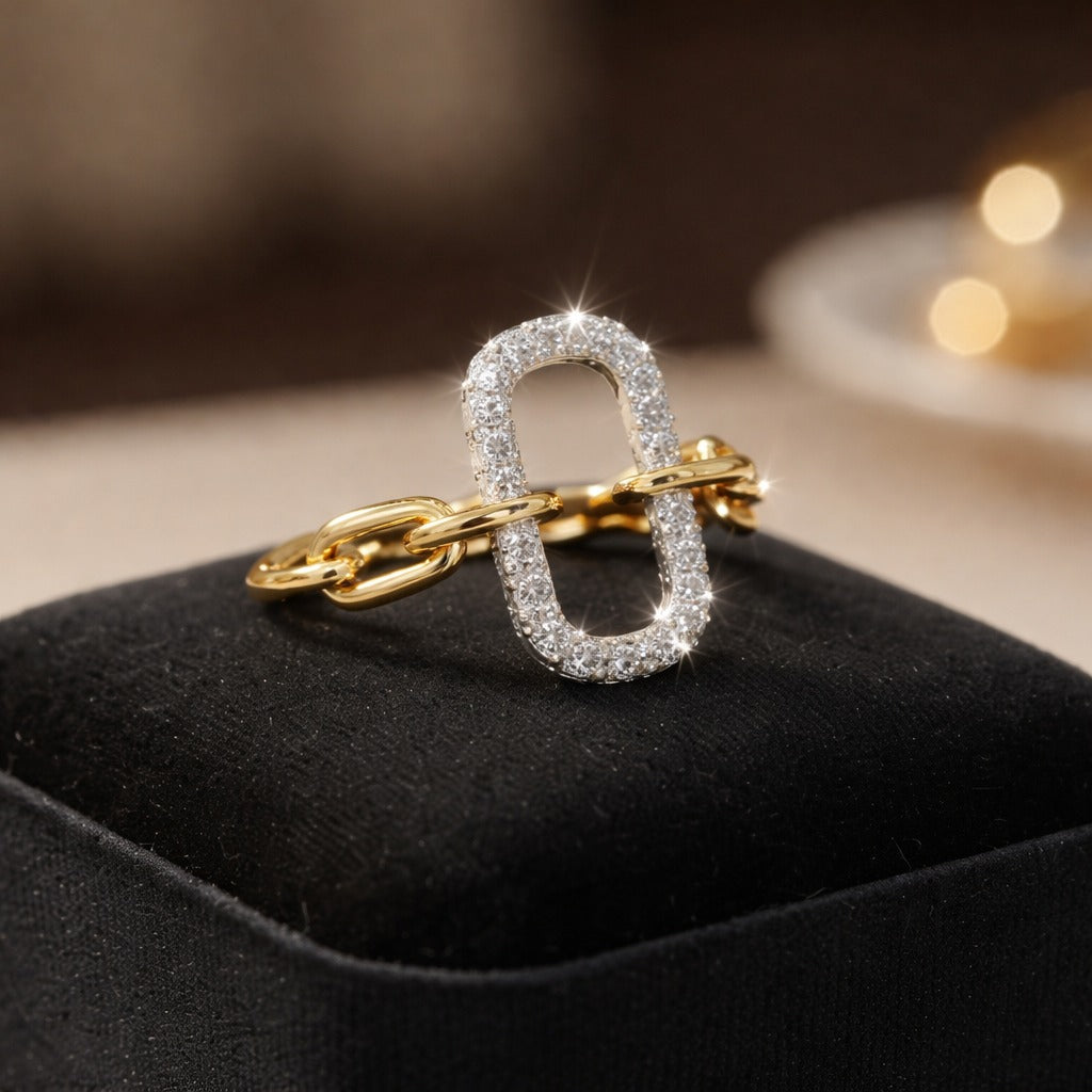 Gold and silver ring on a black cushion with blurred lights in the background