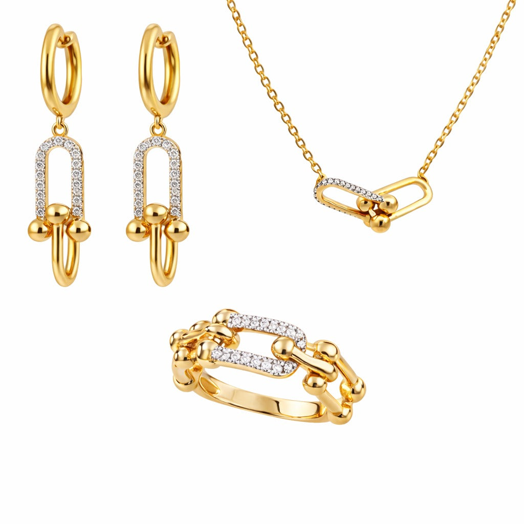 Gold jewelry set with earrings, necklace, and ring on a white background