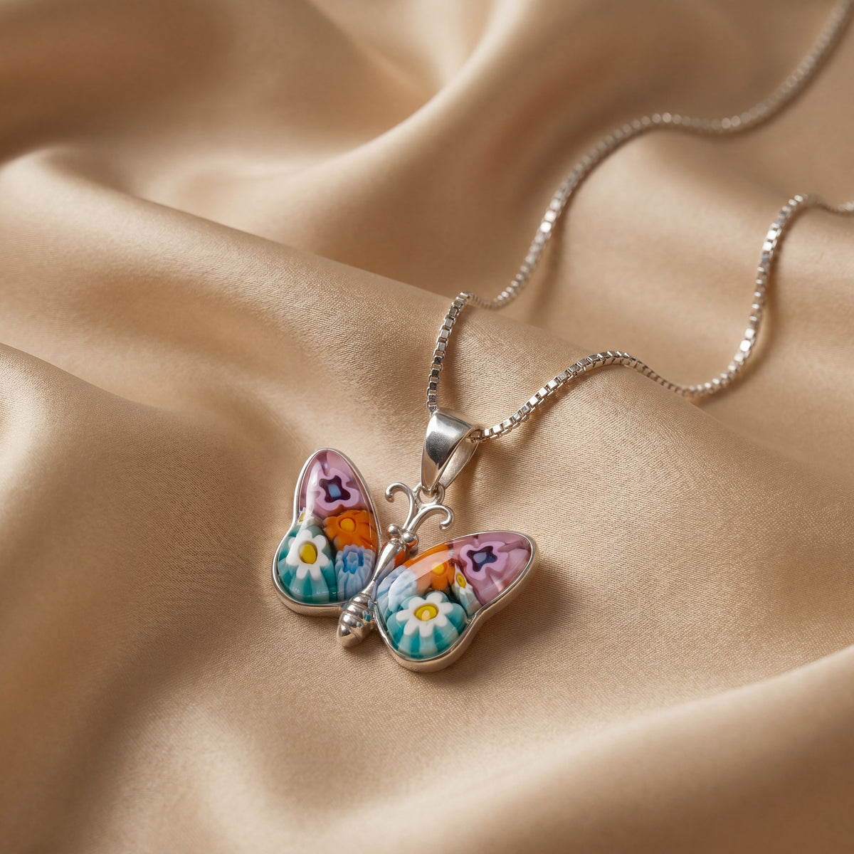 Butterfly-shaped pendant with floral design on a beige fabric background