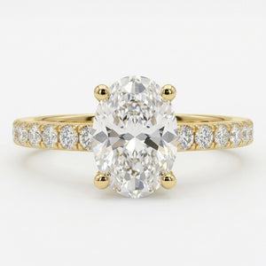 An oval diamond engagement ring with a yellow gold band featuring a row of small round diamonds on either side of the center stone, set against a clean white background.