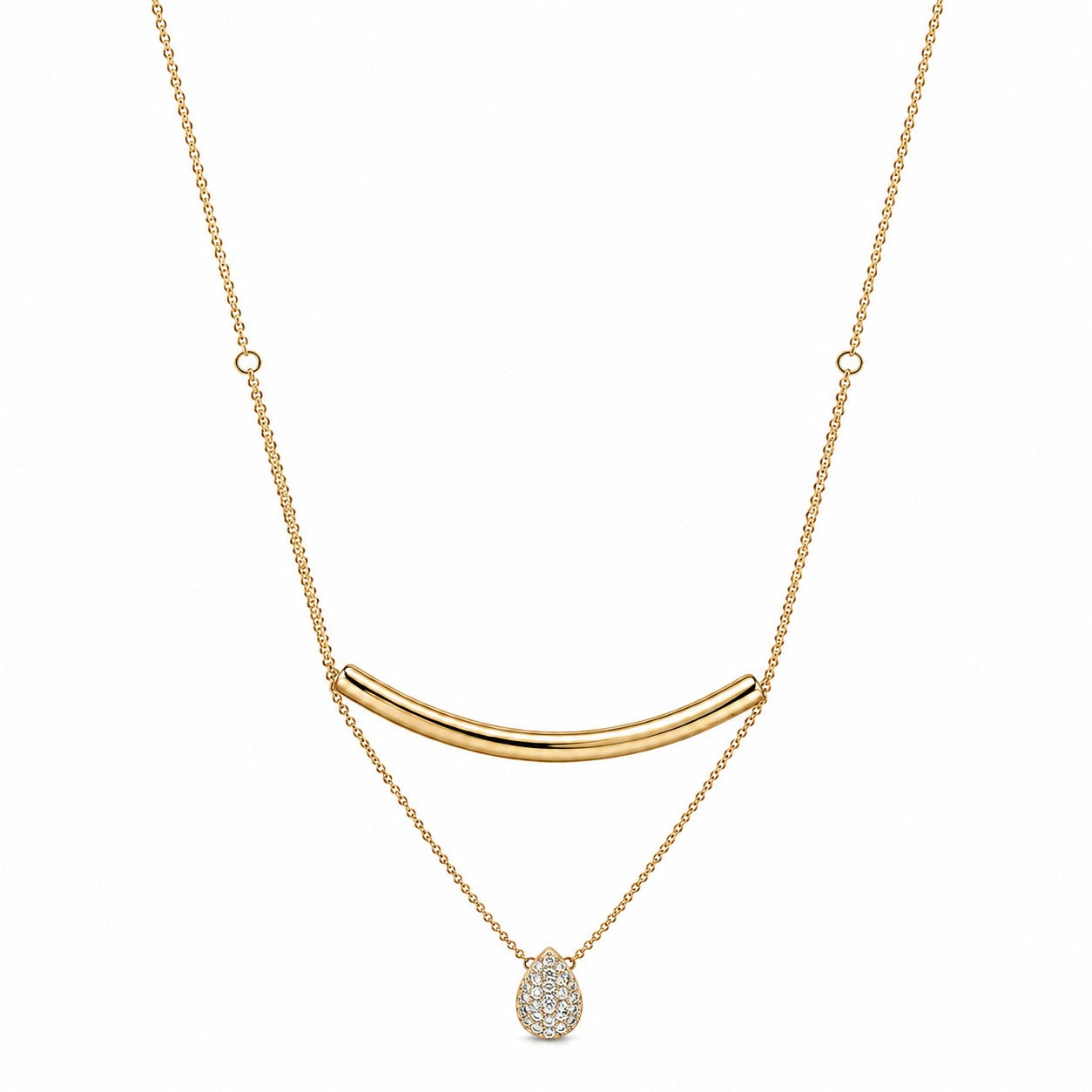 A gold necklace featuring a curved bar pendant, a delicate chain with small circular links, and a teardrop-shaped pendant paved with clear stones, shown against a plain white background.