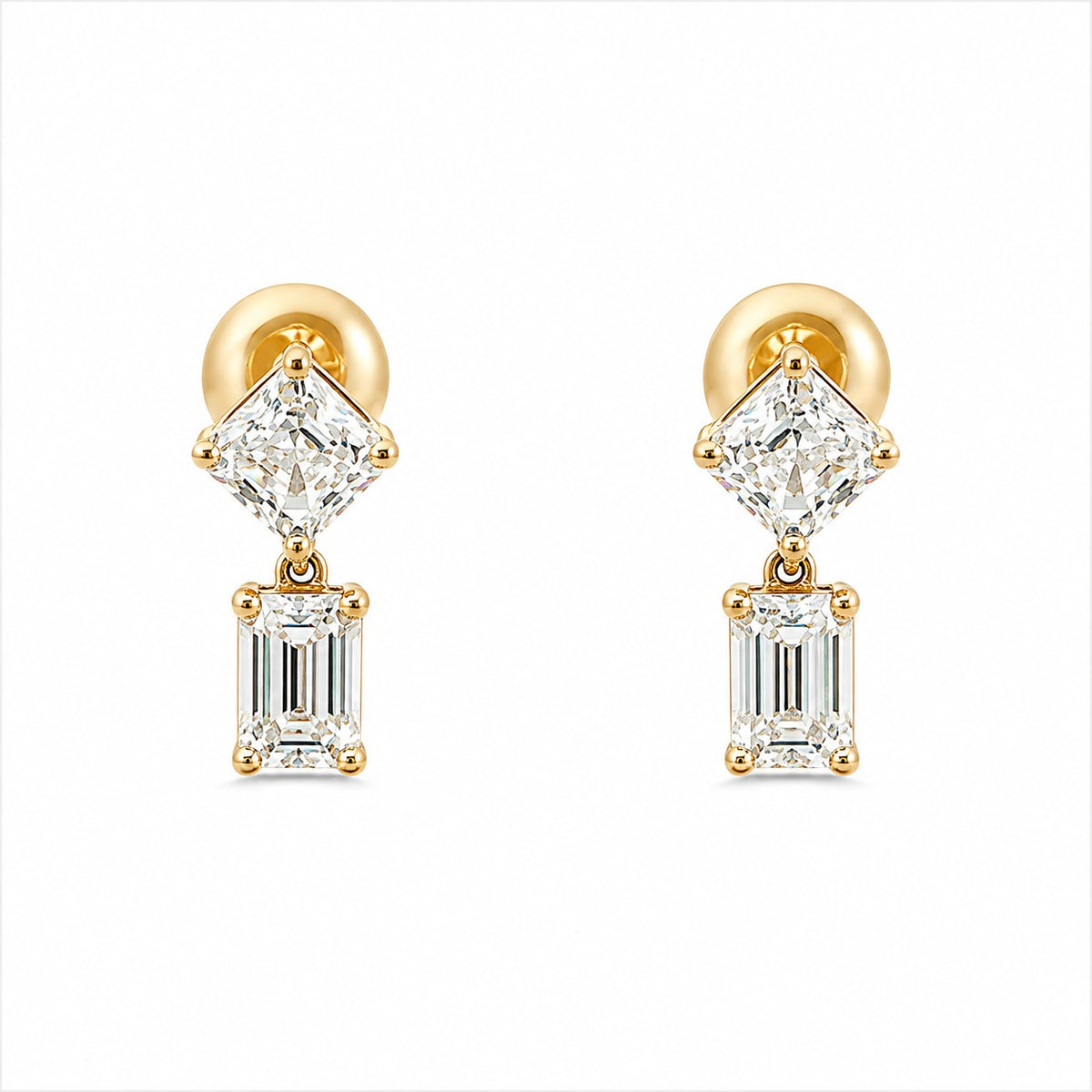 A pair of gold drop earrings featuring a brilliant round-cut clear gemstone above an emerald-cut clear gemstone, set in gold and photographed on a solid white background.