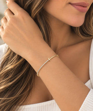 14K yellow gold and titanium bangle bracelet with sparkling diamond accents and a sleek, modern design.