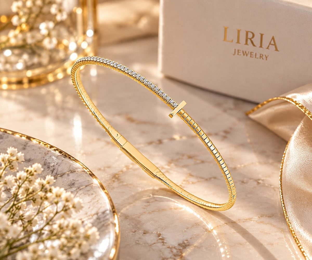 14K yellow gold and titanium bangle bracelet with sparkling diamond accents and a sleek, modern design.