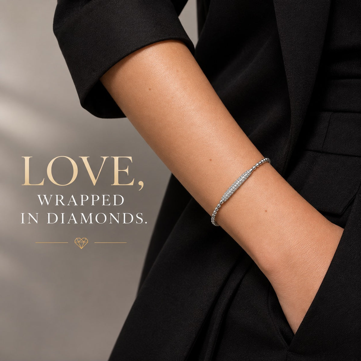 14K white gold diamond bracelet with a delicate beaded design and pavé diamond centerpiece displayed on an elegant beige marble background.
