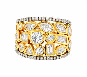 A wide gold ring featuring a geometric pattern of clear gemstones, including round, marquise, and baguette cuts, with diamond-paved borders on a white background.