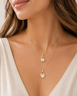 Gold necklace with heart-shaped pendant worn by a model