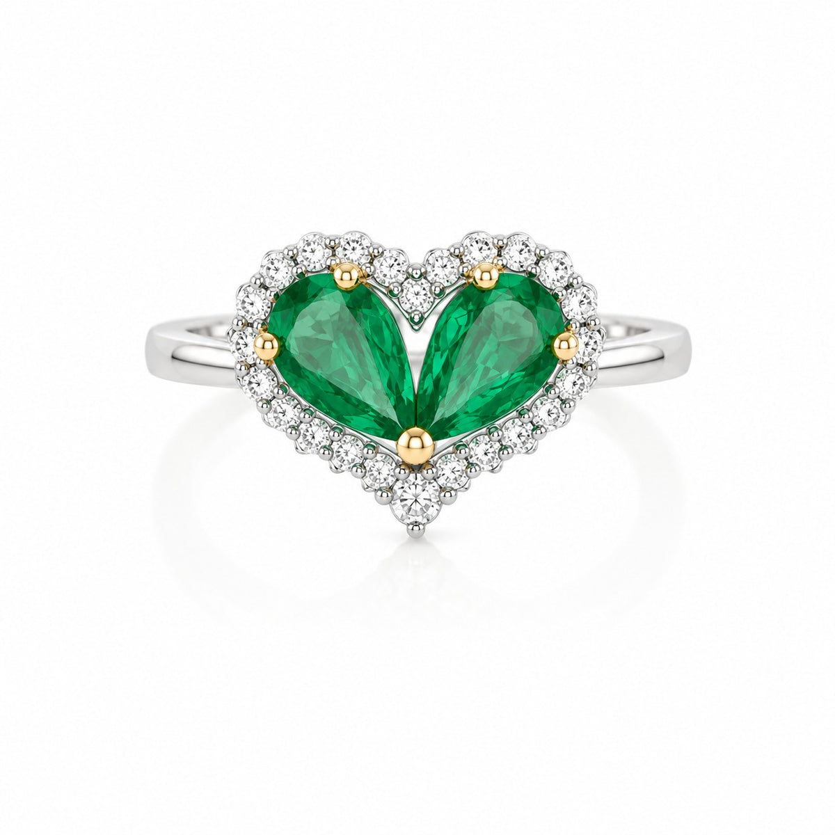 Heart-shaped ring with green pear-cut stones, white halo accents, and a polished white metal band.