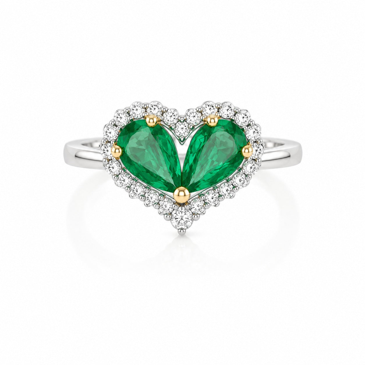 Heart-shaped ring with green pear-cut stones, white halo accents, and a polished white metal band.