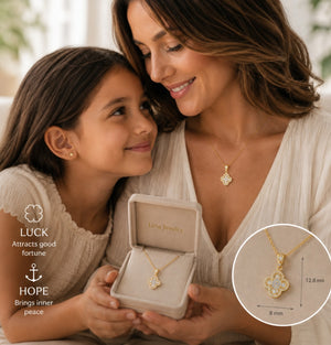 A woman and a young girl both wear matching gold clover-shaped pendant necklaces, while the woman holds an open jewelry box displaying a matching necklace. The image includes a circular inset showing the necklace's dimensions (12.