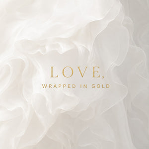 White ruffled fabric background with elegant gold text reading 'LOVE, WRAPPED IN GOLD' centered on the image.