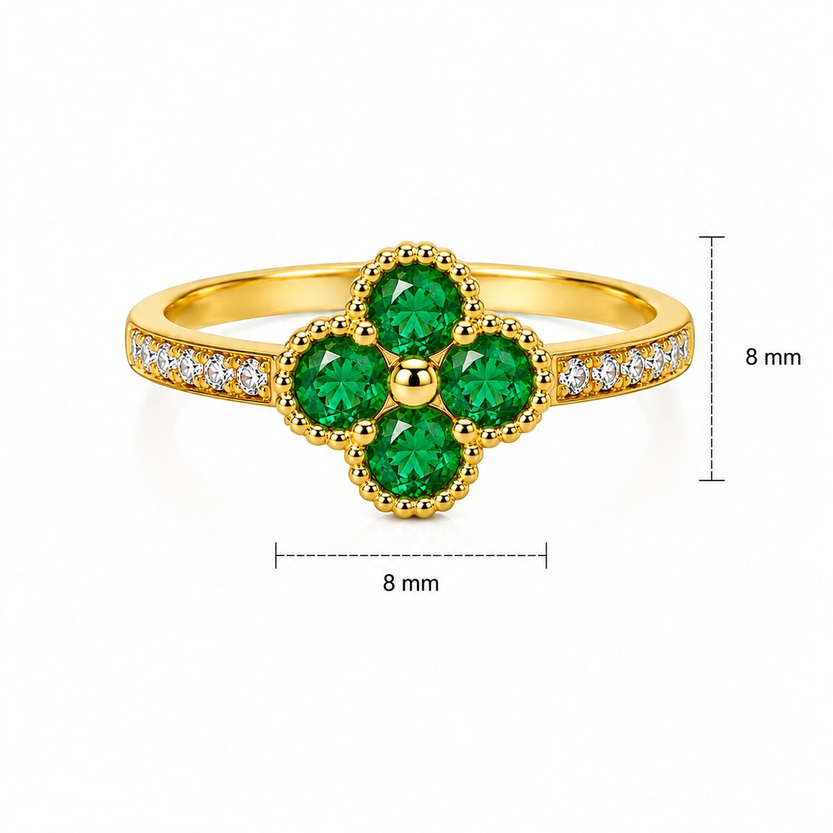 Gold floral ring with four green gemstones and diamond accents on the band.