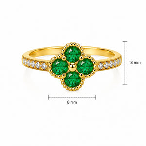 Gold floral ring with four green gemstones and diamond accents on the band.