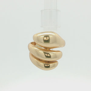 A polished gold ring with a sculptural, organic wavy design, photographed on a clean white background.
