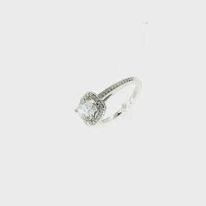 A square halo engagement ring featuring a round brilliant-cut center diamond surrounded by a double halo of smaller diamonds, set on a silver-colored band with pavé diamonds, shown against a plain white background.